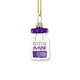 Glass ornament shaped like a Botox vial with purple glitter cap and “Botox Babe” label