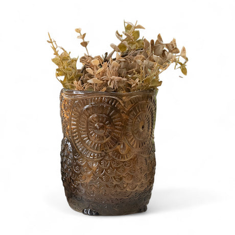 Brown glass owl vase with detailed feather and eye design holding dried stems