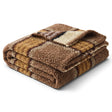 Textured faux sherpa throw blanket with brown, black, and mustard yellow stripes