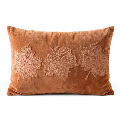 Burnt orange velvet lumbar pillow with dimensional embroidered leaf appliqués