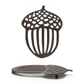 Cast iron acorn shaped trivet with openwork woodland design