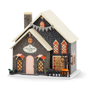 Lighted Cauldron Café Halloween village house with glitter finish, orange windows, black cat, cauldron, pumpkin, and 8-hour timer