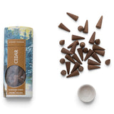 Cedar handmade incense cones with a round white ceramic holder and winter forest printed tube with a gold-colored label