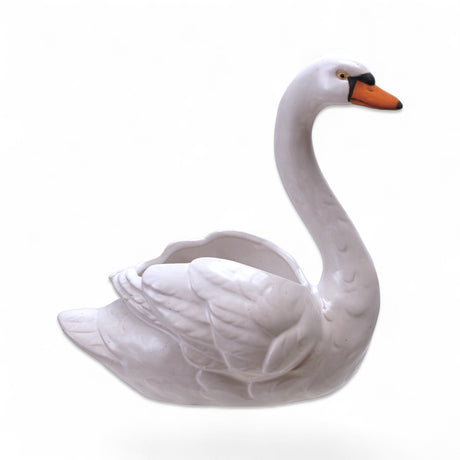 White stoneware swan shaped planter with orange beak and black detail
