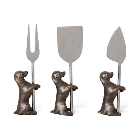 Set of three stainless steel cheese knives with dog-shaped stands in antique silver and brass finish.