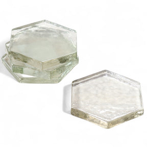 Stack of four clear glass hexagon coasters 