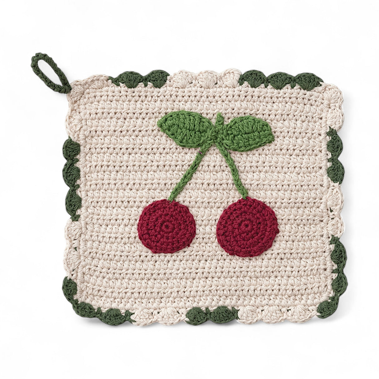 8-inch crocheted cotton pot holder with red cherry design and green scalloped trim