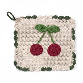 8-inch crocheted cotton pot holder with red cherry design and green scalloped trim