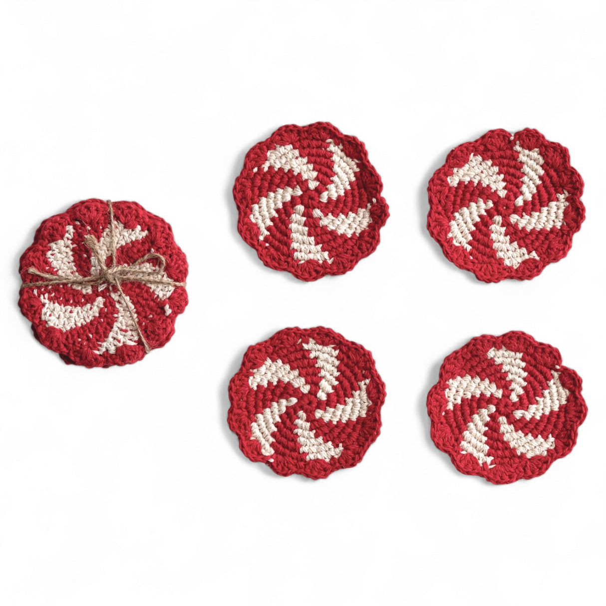 Set of 4 red and natural crocheted candy swirl coasters with scalloped edges tied in jute