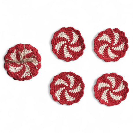Set of 4 red and natural crocheted candy swirl coasters with scalloped edges tied in jute