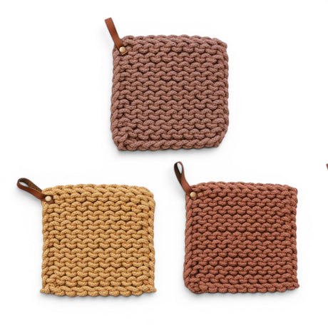 Crocheted cotton pot holders with leather hanging loops in mocha, rust, and mustard