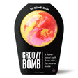 Da Bomb Groovy Bomb yellow bath fizzer with pink and red swirls, Flower Power fragrance and a surprise inside