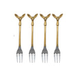  Four appetizer forks with gold-toned deer head handles and silver-toned tines beside an illustrated drawstring bag