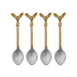  Four coffee spoons with gold-toned deer head handles and silver-toned bowls beside a cream printed drawstring bag