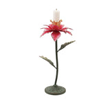 Distressed metal poinsettia taper candle holder with layered red petals, a gold candle cup, green leaves, and a round green base.
