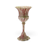 Distressed red metal urn with a scalloped rim, slender stem, fluted pedestal base, and mottled cream and green accents