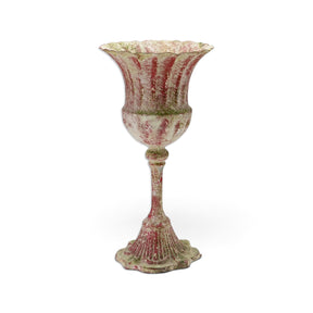Distressed red metal urn with a scalloped rim, slender stem, fluted pedestal base, and mottled cream and green accents