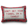Cotton lumbar pillow with red embroidered “Don’t Get Your Tinsel in a Tangle” lettering and a red border with green polka dots.