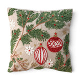 Square cotton Christmas pillow with embroidered green pine boughs, red and white ornaments, white snowflakes, and gold accents