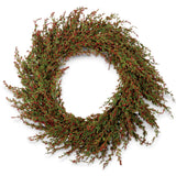 Round faux cypress wreath with full green branches, tiny red berries, and loosely extending sprigs around an open center