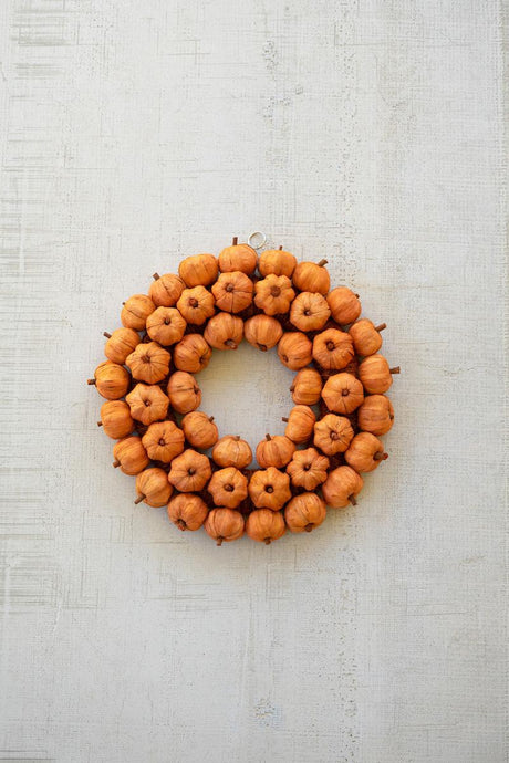 Natural dried botanical details on an orange pumpkin wreath