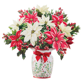 Festive poinsettia pop-up paper bouquet with red and white poinsettias, holly leaves, berries, and decorative Christmas vase