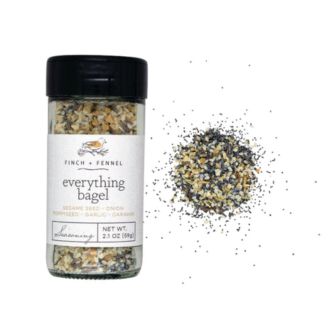 Finch + Fennel Everything Bagel Seasoning jar beside seasoning blend and toast sprinkled with seasoning