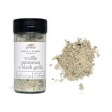 Finch + Fennel Truffle Parmesan + Black Garlic Seasoning jar beside seasoning blend and fries on cutting board