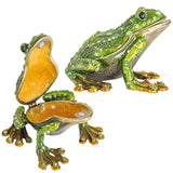 A green enameled metal frog-shaped trinket box with sparkling jewel accents, shown both closed and open with its hinged lid.