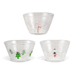 Three clear glass holiday bowls with bubbled details and embedded red candy canes, green Christmas trees, or snowmen