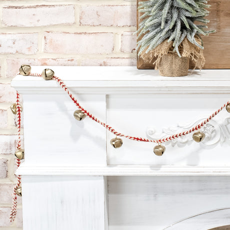gold bell garland on red and white braided cord