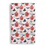 Halloween-themed towel with pumpkins, ghosts, and bats on a white background