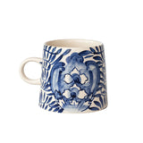  Hand-painted stoneware mug with blue floral design on a cream base, 10 oz. capacity.