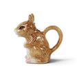 Hand-painted brown ceramic mouse creamer with rounded ears, a cream-colored belly, pink paws, and a curled tail handle