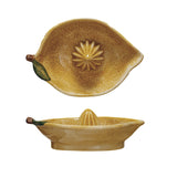 ellow hand-painted stoneware lemon-shaped juicer with green leaf accent.