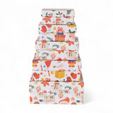 Stacked handmade recycled paper gift boxes with holiday prints