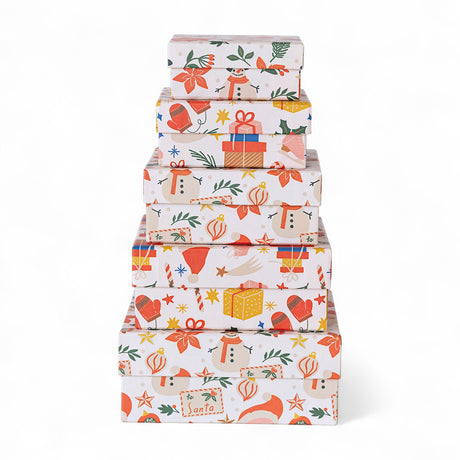 Stacked handmade recycled paper gift boxes with holiday prints