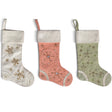 Handmade wool felt Christmas stockings in cream, coral pink, and sage green with embroidered snowflakes, beads, and cream cuffs