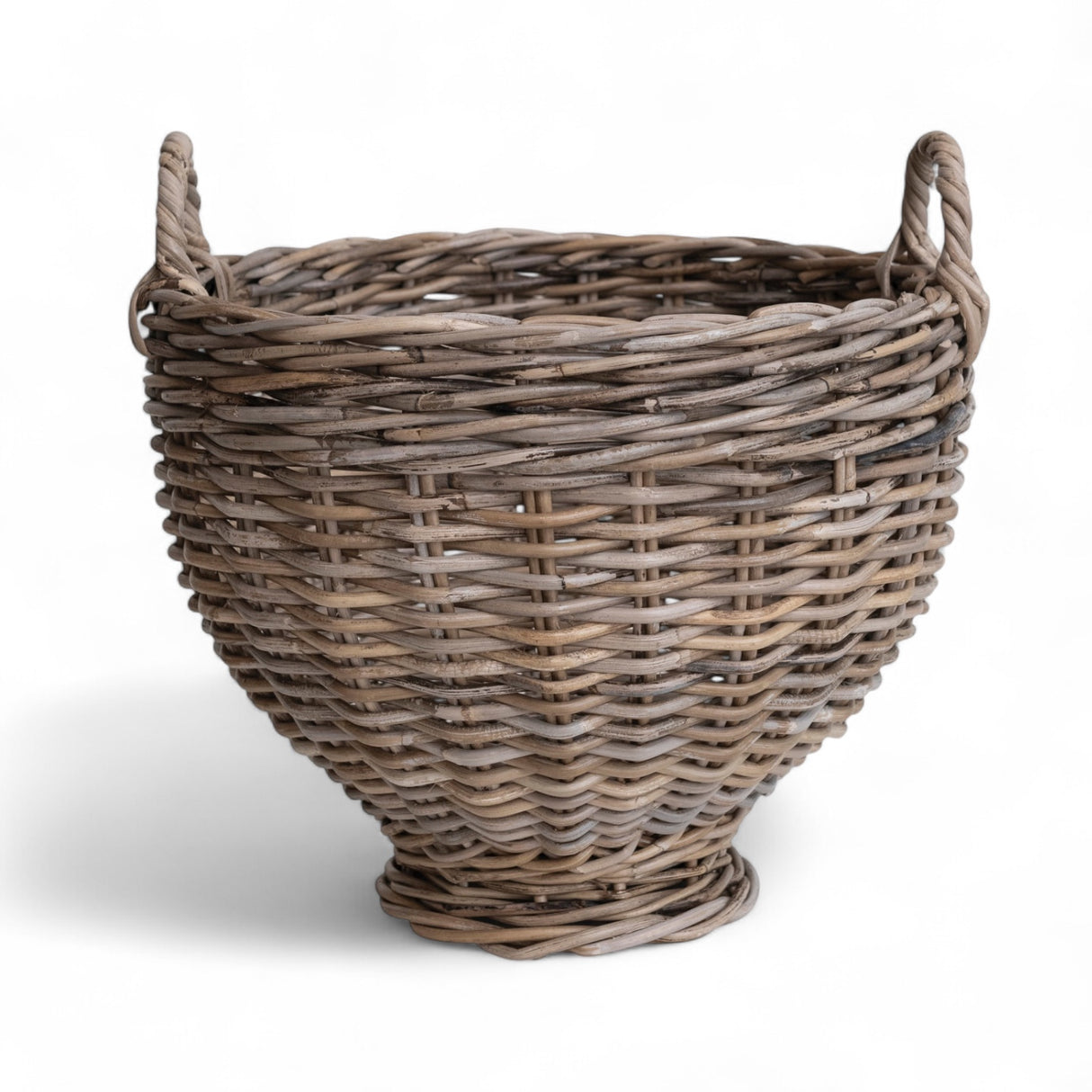 Handwoven rattan footed basket with handles in a natural finish, measuring 15.75 inches round and 16 inches high.
