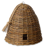 Handwoven willow bee skep with a rope accent, displayed on a white wooden stool.