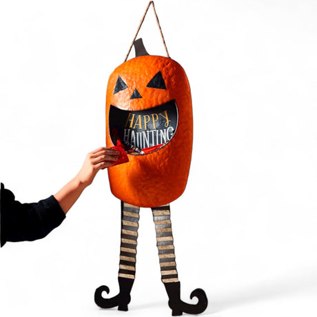 Jack-o’-lantern candy door hanger with open mouth bucket design and striped legs