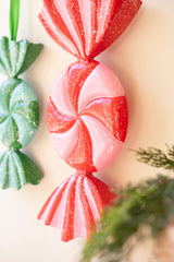 Painted metal wrapped candy ornaments with glitter details