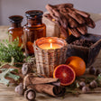 Leather and oak candle in woven willow container for rustic home fragrance
