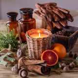 Leather and oak candle in woven willow container for rustic home fragrance
