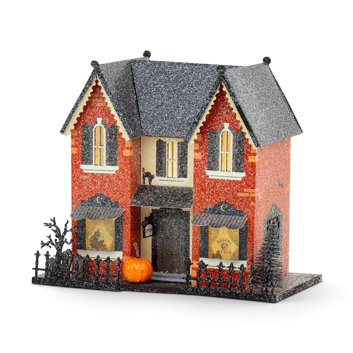 Madame Mystic lighted Halloween village house with orange glitter exterior, glowing windows, pumpkin, fencing, and 8-hour timer