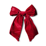 Large maroon velvet Christmas bow with long tails
