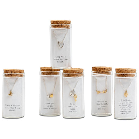 message necklaces displayed in clear glass vials with cork tops and printed quote cards by sugar boo
