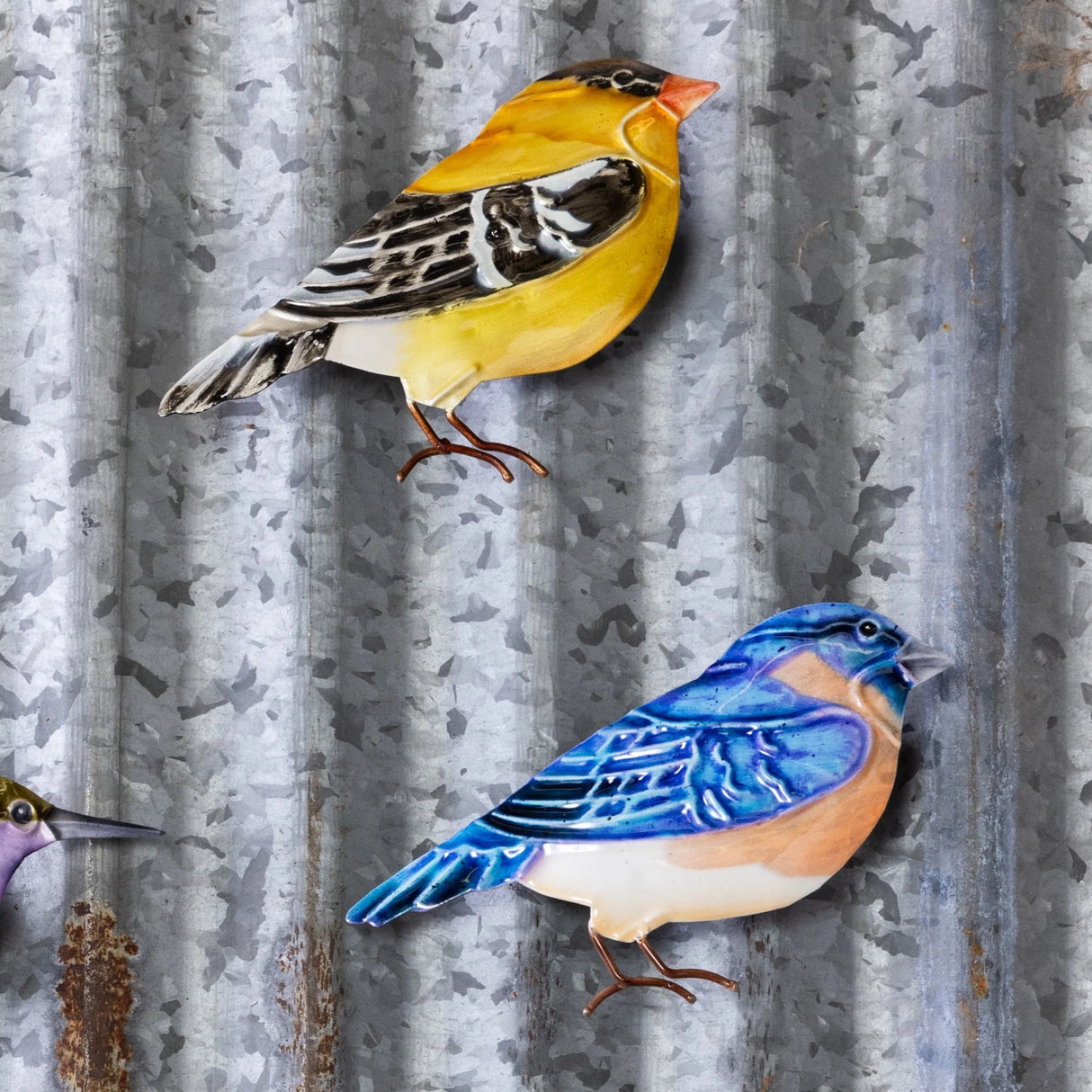 Hand-painted tin bird magnets in yellow and blue with metal legs