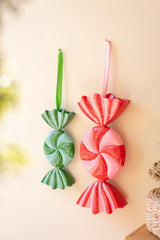 Painted metal candy ornaments displayed as colorful Christmas decor