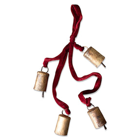 Vintage-style metal Christmas bell cluster with four bells on a velvet rope, measuring 25" long, ideal for holiday decor.